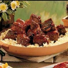 meat and rice in a bowl on a table