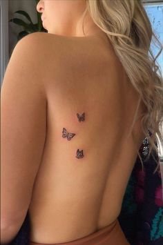 a woman with three butterflies on her back