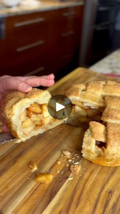 a person cutting up some food on top of a wooden cutting board with a knife