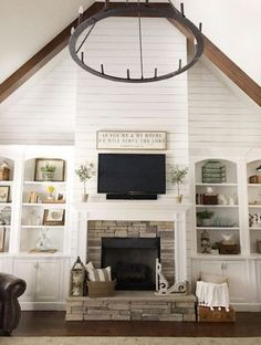 a living room filled with furniture and a flat screen tv mounted on the wall above a fireplace