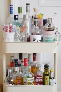 a bar cart filled with liquor bottles and drinks