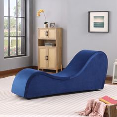 a blue bean bag chair sitting on top of a white rug