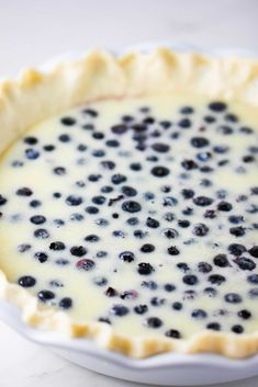 a blueberry pie sitting on top of a white plate