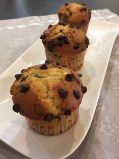 three chocolate chip muffins on a white plate