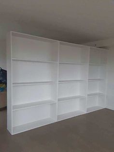 empty white bookcases in an empty room