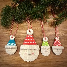 three christmas ornaments hanging from a tree on top of a wooden table with candy canes