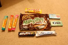 various candy bars are laid out on the floor