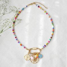 Colorful beaded carabiner necklace is such a unique seed bead necklace with your choice of gold and colorful charms! In this necklace, I have paired small (4 mm) colorful glass seed beads beads with a large 14k gold plated carabiner lock and your choice of charms. The carabiner lock opens so you can also add your favorite charms. The length of the necklace is 16 inches, with 2 inches extension chain so you can adjust the necklace between 16 and 18 inches (40 - 46 cm). Gold-plated and stainless s Name Bead Necklace, Beaded Carabiner, Carabiner Necklace, Custom Charm Necklaces, Blue Charm, Custom Charms, Seed Bead Necklace, Beaded Jewelry Diy, Bead Necklace