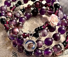 "Welcome to my Shop \"CREATING STILL MOMENTS.\"   To see all my listings and offerings, please visit my shop at  https://www.etsy.com/shop/CreatingStillMoments?ref=sh-carousel- Handmade Rosary Bracelet Semi-precious purple agate beads Memory Wire Mary Medal silver crucifix with St Benedict medal and lavender rose bead for added pop of color Catholic mom gift  Beads of brilliant color!  These rosaries are beautiful and would make a wonderful RCIA Gift or Confirmation gift! The colors are vibrant Purple Round Beaded Jewelry For Mother's Day, Handmade Adjustable Purple Rosary, Handmade Spiritual Purple Rosary Bracelet, Adjustable Purple Rosary Bracelet, Adjustable Purple Spiritual Rosary Bracelet, St Benedict Medal, Handmade Rosary, Benedict Medal, Beaded Memory Wire