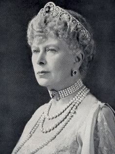 an old black and white photo of a woman with pearls on her head wearing a tiara