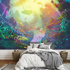 a bedroom with a large wall mural in the middle and colorful artwork on the walls