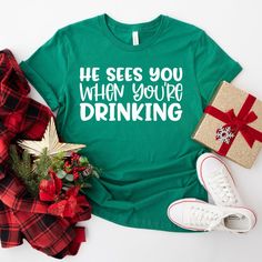 Funny Christmas Shirts - He Sees You When Your Are Drinking Tee - He Knows Your Booze Intake Shirt - Drinking Shirt - Christmas Party Shirt TEES ARE: Made of 100% soft cotton High quality, comfortable, soft and designed to last Custom created, pressed and packaged right here in Sydney Australia Please refer to the sizing chart included in the listing for garment measurements. If purchasing the shirt for / during pregnancy, we recommend sizing up. 👕 CARE INSTRUCTIONS - Wash inside out - Cold Mac Christmas Party Shirt, Christmas Party Shirts, Faith Shirt, Funny Christmas Shirts, Drinking Shirts, Wonderful Time Of The Year, Sydney Australia, Funny Christmas, Christmas Shirt