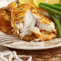 a white plate topped with chicken and green beans