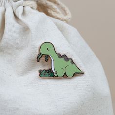 Who can resist that cute face? Not even the fussiest of eaters will be able to turn down their veggies when they see this adorable Bronti enamel pin. It's the perfect way to show your love for all things green! Size: 1.2" x 1.6" All Things Green, Animal Pins, Enamel Pin Collection, Pretty Pins, Cute Face, Enamel Lapel Pin, Cool Pins, Hand Art, Simple Doodles