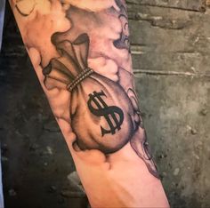 a man's arm with a bag of money on it