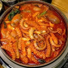 an octopus stew is in a pot on the stove