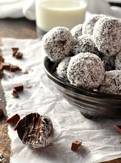 a bowl full of chocolate truffles sitting on top of a table