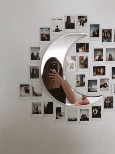 a woman taking a selfie with her cell phone in front of a crescent shaped mirror