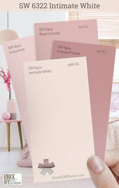 someone holding up some pink paint swatches in their hand with the words sw 632 intimate white on them