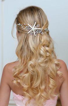 a woman with long blonde hair wearing a starfish headpiece in her hair and pink dress