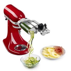 a red kitchen aid hand mixer and bowl with pasta