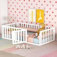 a baby's room with pink walls and hearts on the wall, including a crib