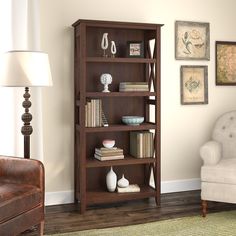 a living room with a chair and bookshelf