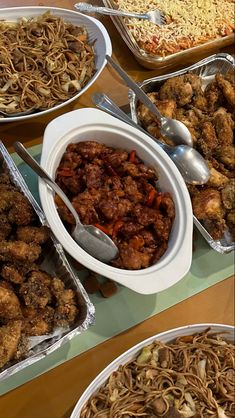 several plates of food on a table with spoons and bowls filled with different types of food