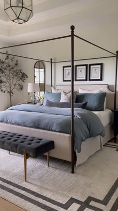 a bed room with a neatly made bed next to a window and a chandelier