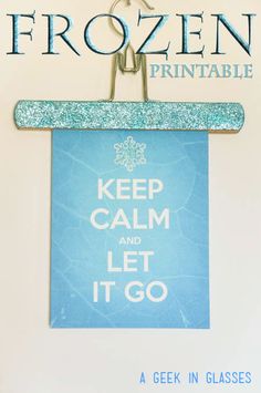 a frozen printable is hanging on the wall next to a sign that says keep calm and let it go