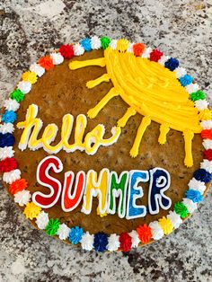 a cookie with the words hello summer written on it and decorated in colorful icing