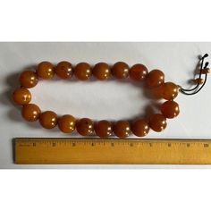 Large natural Baltic Amber worry beads strung on a fabric cord. Each round bead measures under 1" diameter. Strand includes 19 large beads and 3 small beads. Must be restrung on a longer cord if you wish to wear these beads as a necklace. Originally used as worry beads in the hand. Wonderful color and natural inclusions. Adjustable Amber Beaded Necklace With Large Beads, Adjustable Polished Amber Beads, Adjustable Beaded Necklace With Large Beads For Healing, Amber Beaded Necklaces With Large Round Beads, Vintage Beaded Necklaces With Round Beads For Meditation, Spiritual Large Amber Beads, Adjustable Wooden Round Beads, Amber Healing Beads With Large Beads, Amber Spiritual Round Beads