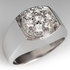 This handsome mens ring is centered with a cluster of seven (7) prong set round brilliant cut diamonds. The ring measures 13.6mm at the top, rises 8.3mm above the finger, tapering to 4.1mm wide and 1.4mm thick at the base of the shank. The ring is crafted in 14k white gold and is currently a size 8.75. Two of the diamonds are unnoticeably chipped. Luxury Elegant Men's Cluster Ring, Luxury Brilliant Cut Cluster Ring For Men, Luxury Classic Men's Cluster Ring, Luxury Men's Round Cluster Ring, Luxury 14k White Gold Silver Cluster Ring, Luxury Polished Finish White Gold Cluster Ring, Mens Ring, Diamond Cluster Ring, Diamond Cluster