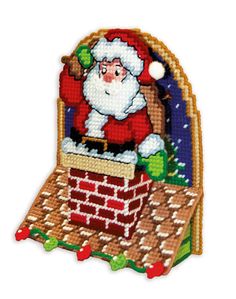 a cross stitch santa clause sitting on top of a brick chimney in front of a christmas tree