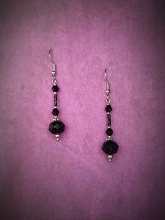 Elevate your gothic Victorian style with these stunning black facetted bead and silver dangle earrings. The intricate design of these earrings captures the essence of a bygone era, combining the dark elegance of gothic fashion with the intricate details of Victorian style. Perfect for adding a touch of drama to any outfit, these earrings are sure to make a statement wherever you go. Handcrafted with care and attention to detail, these earrings are a unique and stylish addition to your jewelry co Gothic Black Drop Earrings, Black Metal Drop Beaded Earrings, Black Metal Round Beads Earrings, Black Metal Earrings With Round Beads, Nickel-free Black Beaded Drop Earrings, Black Faceted Beads Dangle Jewelry, Nickel Free Black Round Bead Earrings, Black Beaded Sterling Silver Earrings, Black Dangle Jewelry With Faceted Beads