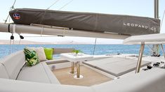 the interior of a sailboat with an outdoor table and seating area on the deck