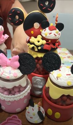 mickey and minnie mouse cupcakes are on the table