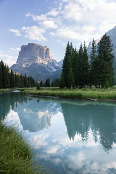 the mountains are reflected in the clear water