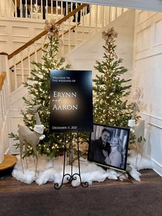 a christmas tree with two pictures on it in front of a staircase