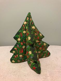 three green christmas trees sitting on top of a table