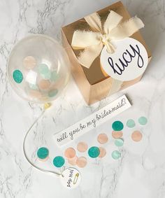 a gift box and some confetti on a marble table with a tag that says you are the best