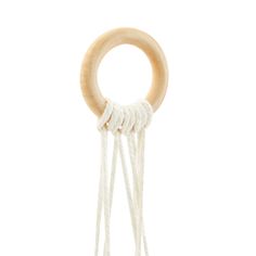 a wooden ring with white string hanging from it's side on a white background