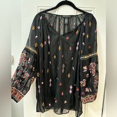 Looks Better With Black Cami Under Bust- 46in Never Worn Very Airy And Embroidery Is Super Cute *Pet Free And Smoke Free And Cleaned Before Sending* Black V-neck Blouse With Floral Embroidery, Fall Black Top With Floral Embroidery, Black Long Sleeve Embroidered Top With Floral Print, Casual Black Embroidered Top With Geometric Design, Casual Black Top With Geometric Embroidery, Black Long Sleeve Blouse With Embroidered Sleeves, Black Long Sleeve Top With Geometric Embroidery, Black Long Sleeve Top With Intricate Embroidery, Casual Black Blouse With Geometric Embroidery