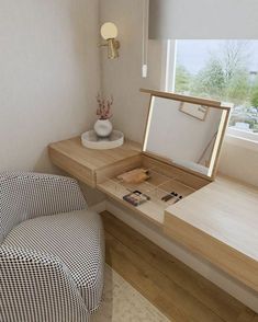 a chair and desk in a small room with a mirror on the window sill