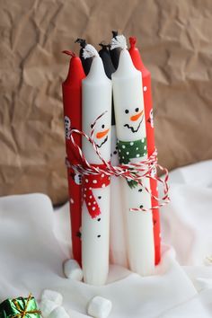 three snowman candles tied to each other