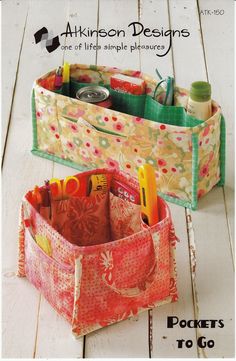 two storage bins sitting on top of a wooden floor