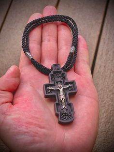 Dimensions: 2.5 inch x 1.3 inch (0.5 inch thick) This eight-pointed pectoral Orthodox cross of the classical form is carved from ebony, with the jeweler's precision according to all Orthodox canons. The value of ebony is not only in its unusual color, but also in its strength. Treated with natural oil, which protects it against moisture and perfectly shows the structure of the tree. The crucifixion of the Savior is made of premium 925 Sterling Silver. This cross is anti-allergic and made to last Black Engraved Pendant Cross Necklace, Handmade Black Crucifix Necklace, Handmade Black Cross Pendant Necklace, Black Engraved Cross Necklace Gift, Engraved Black Cross Necklace As Gift, Engraved Black Cross Necklace For Gift, Gift Black Engraved Cross Necklace, Handmade Black Cross Necklace, The Crucifixion