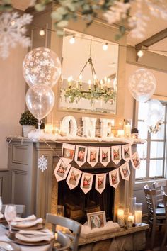 a decorated fireplace with balloons and candles on the mantel in front of it is one year old