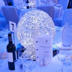 the table is set up with wine glasses, plates and silverware for an elegant dinner