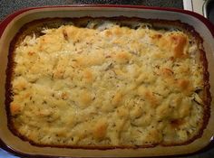 a casserole dish with cheese and herbs in it